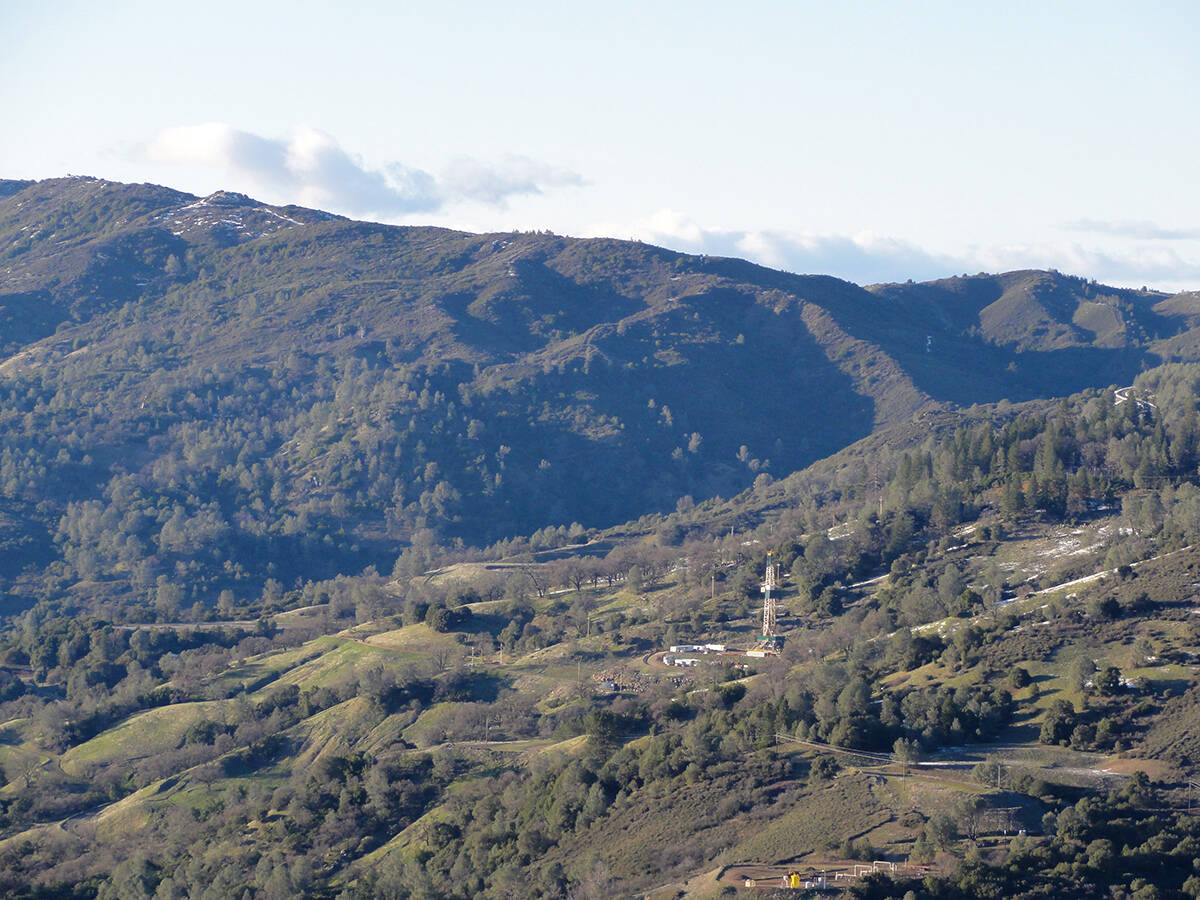 Geothermal drilling rig on a forested hillside at The Geysers geothermal field. Courtesy of Constellation Energy.